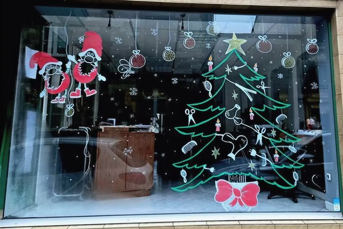 Vitrine avec sapin de Noël décoré d'objets de coiffure